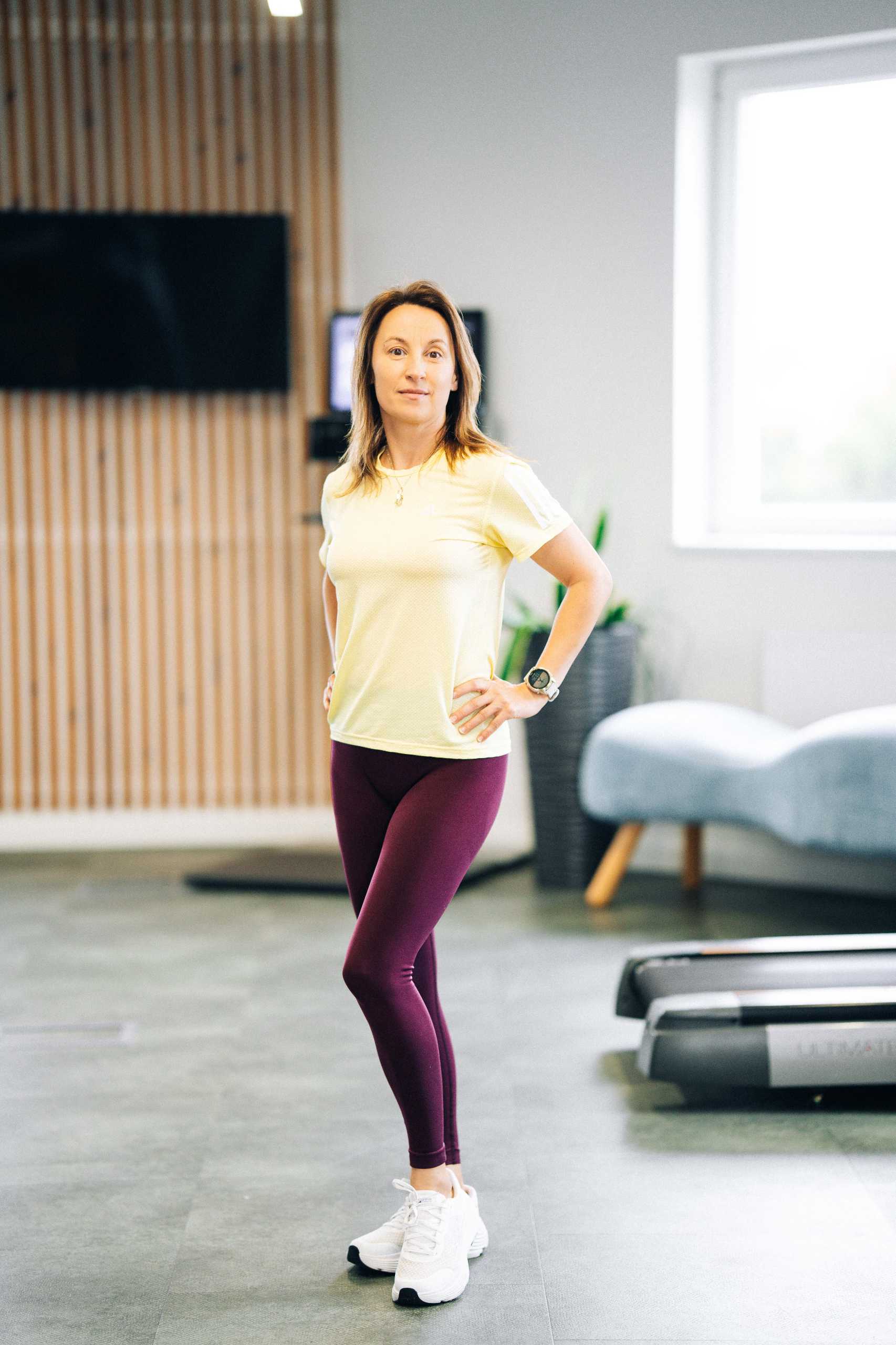 Fotografia wizerunkowa w Szczecinie — trenerka fitness w akcji, prezentująca dynamiczną postawę w Klubie Fitnes 3L.