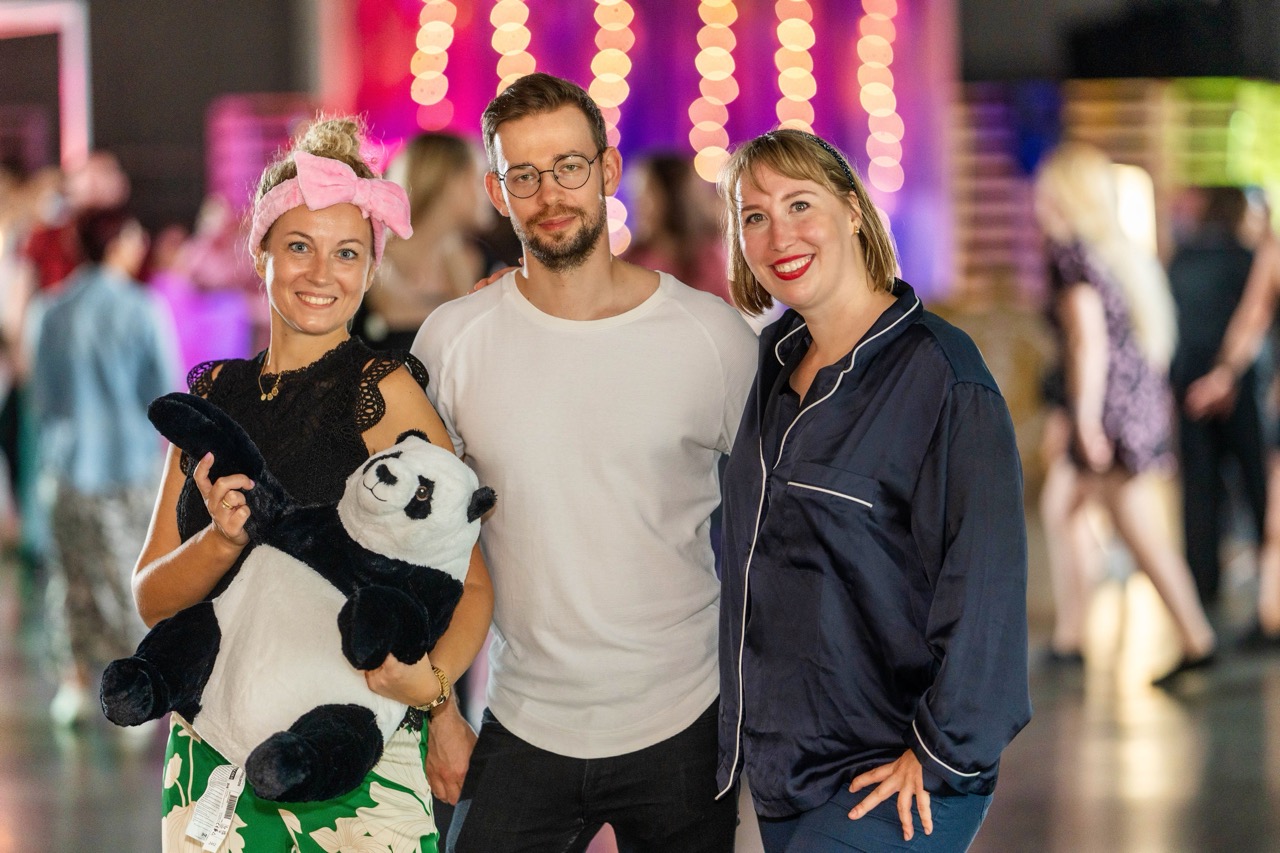 Uczestnicy wydarzenia dla IKEA w Szczecinie pozują do zdjęcia z maskotką pandy w rękach jednej z osób.